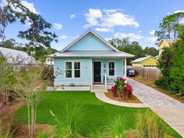a front view of a house with a garden and patio