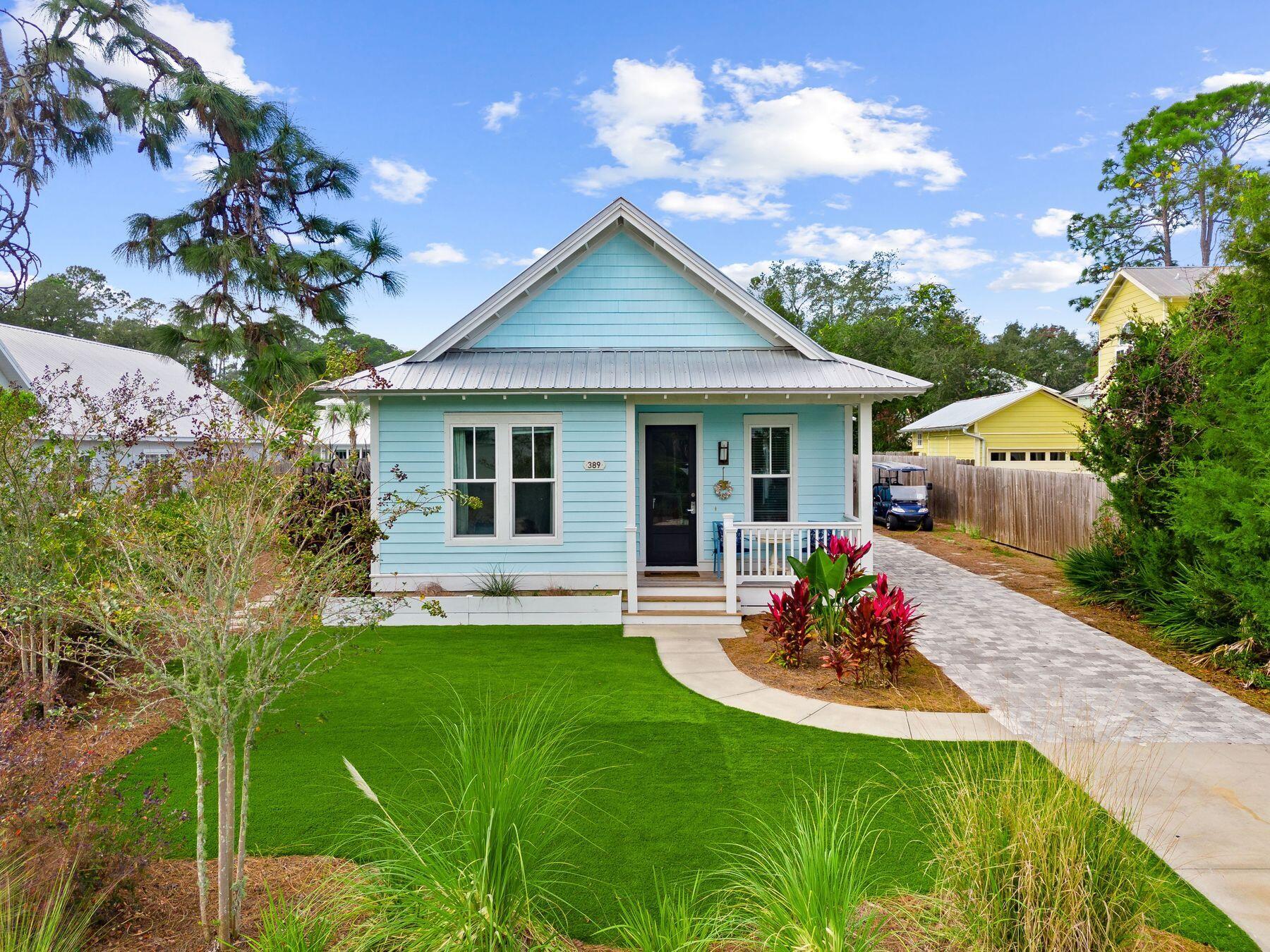 389 Seacrest Drive Seacrest, FL 32461 - Photo 25 of 33 a front view of a house with a garden and patio