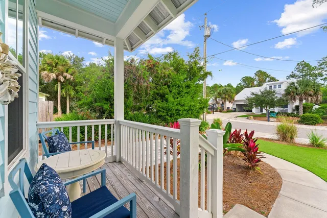 a view of a porch with furniture and garden