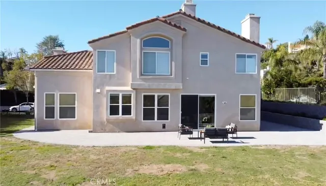 a view of a house with backyard porch and sitting area