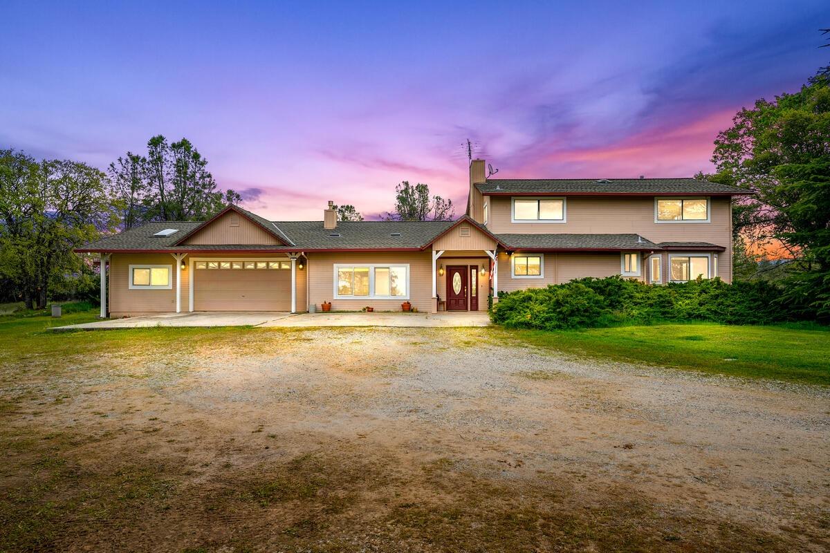 a front view of a house with a yard and garage