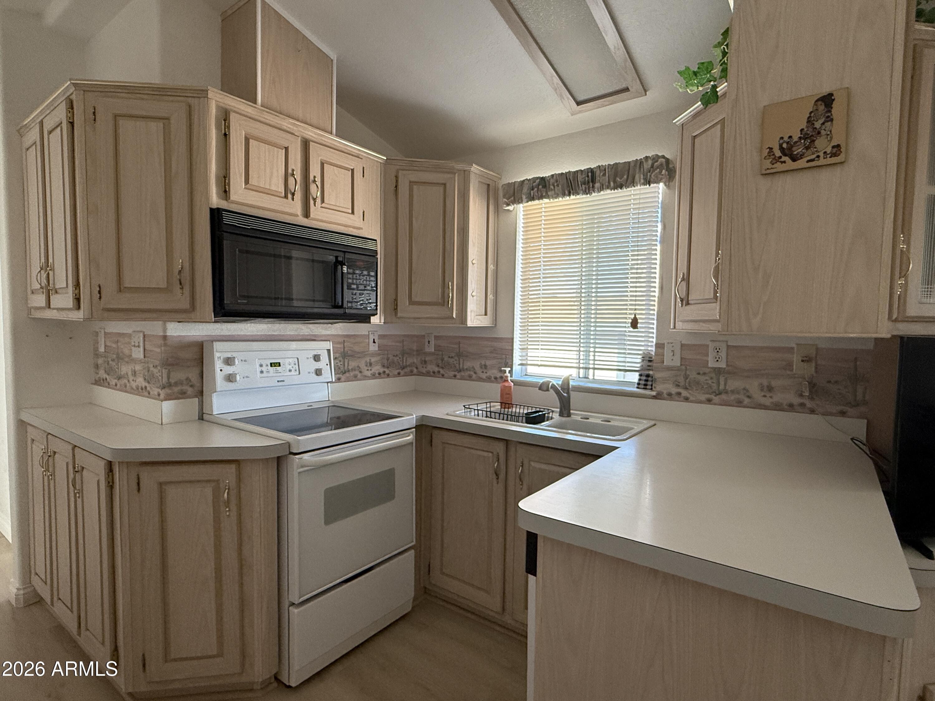 21340 Trading Post Trail Congress, AZ 85332 - Photo 5 of 31 a kitchen with a sink stove and microwave