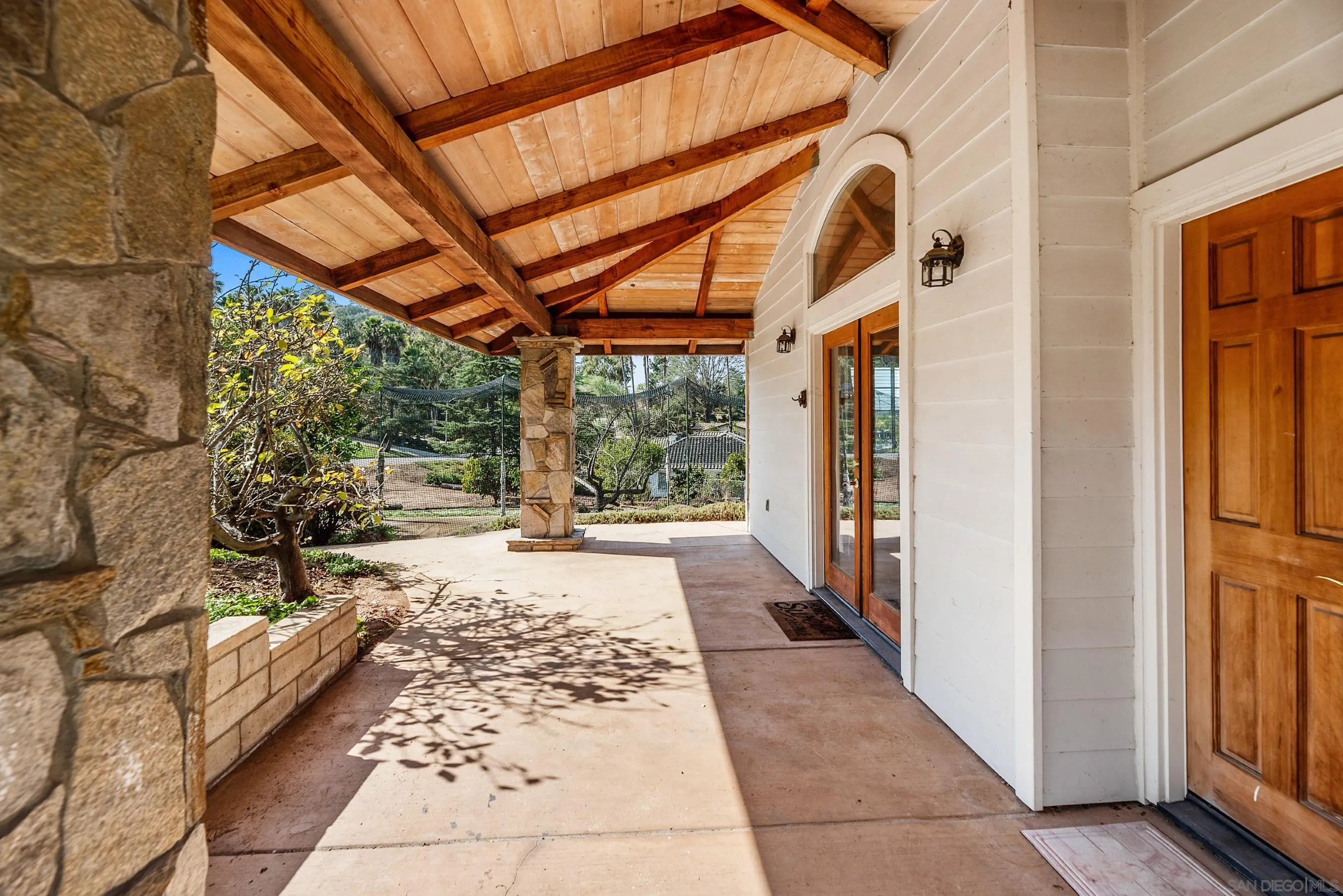 13338 Arroya Vista Road Poway, CA 92064 - Photo 54 of 55 a view of a porch with wooden floor and front door