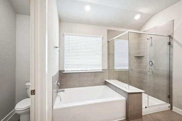 a bathroom with a bathtub a toilet and a shower