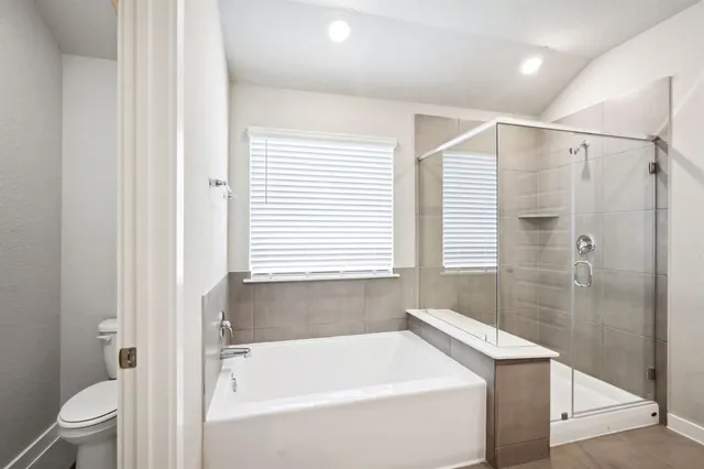 a bathroom with a bathtub a toilet and a shower