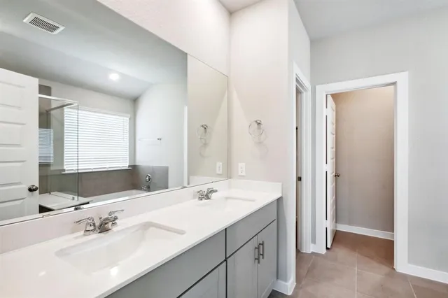 a bathroom with a double vanity sink mirror and double