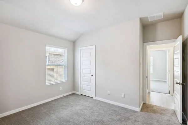 an empty room with windows and closet