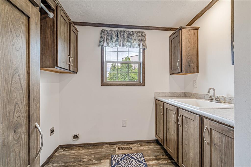 120 Buckeye Road Mount Pleasant, PA 15666 - Photo 23 of 26 Dedicated laundry room with hanging clothes rod, sink, and storage. The furnace is also located in this room.