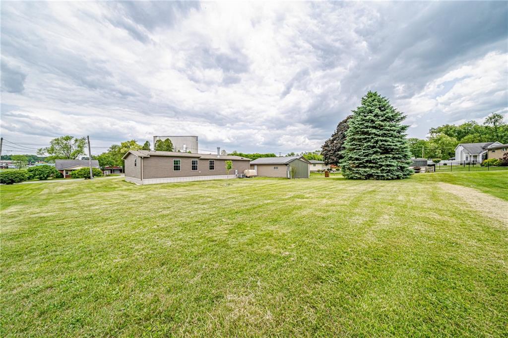 120 Buckeye Road Mount Pleasant, PA 15666 - Photo 4 of 26 Situated on ~1/2 acre level lot. Great for kids to play. Add a pool. Cornhole anyone? Rear yard is equipped with invisible animal fence.