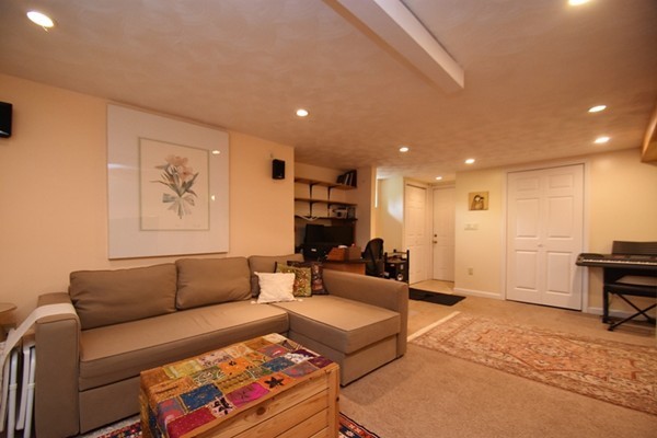 55 Christopher Road Waltham, MA 02451 - Photo 15 of 19 a living room with furniture and a flat screen tv