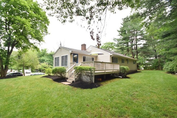 55 Christopher Road Waltham, MA 02451 - Photo 18 of 19 a front view of a house with a garden and trees