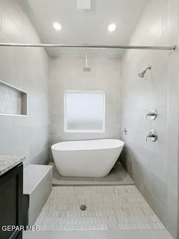 a bathroom with a bathtub and shower