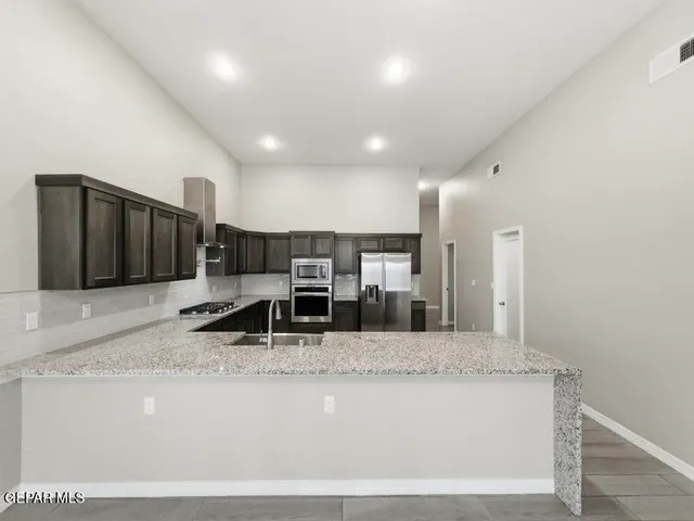 a view of kitchen with refrigerator and window