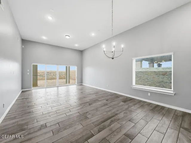 a kitchen with kitchen island granite countertop a sink and a stove top oven