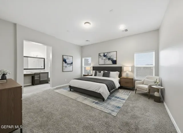 a spacious bedroom with a bed and a flat screen tv