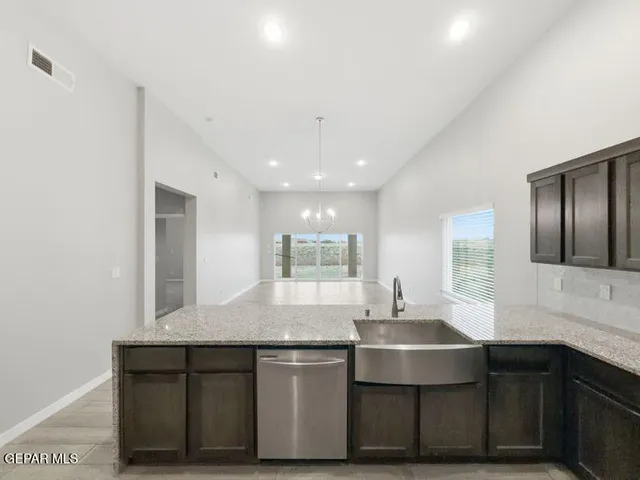 a kitchen with stainless steel appliances wooden cabinets and a granite counter top