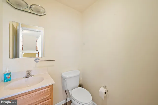 a bathroom with a sink toilet and mirror