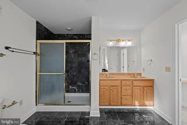 a bathroom with a granite countertop sink and mirror