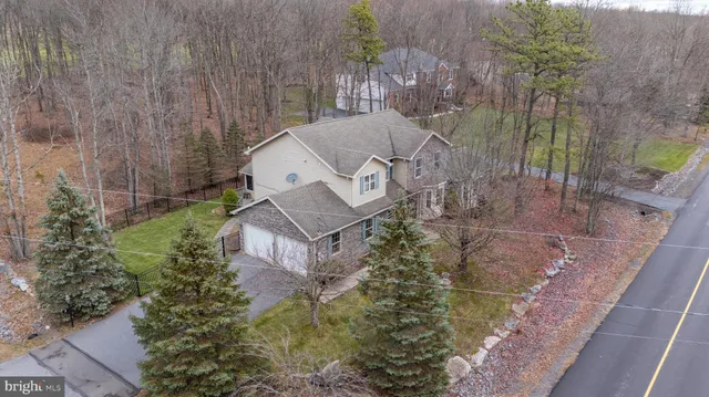 an aerial view of a house with a yard basket ball court
