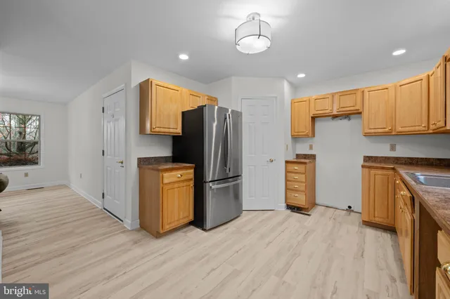 a kitchen with stainless steel appliances a refrigerator and a stove top oven