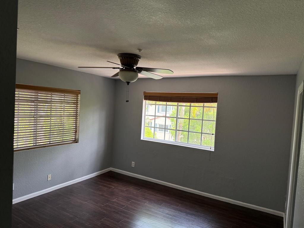 4573 Danson Way Delray Beach, FL 33445 - Photo 12 of 31 a view of an empty room with a window and wooden floor