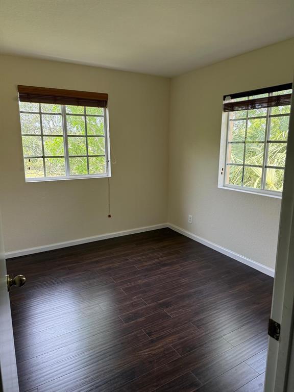 4573 Danson Way Delray Beach, FL 33445 - Photo 14 of 31 a view of an empty room with wooden floor and a window