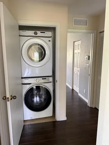 a view of a hallway with washer and dryer
