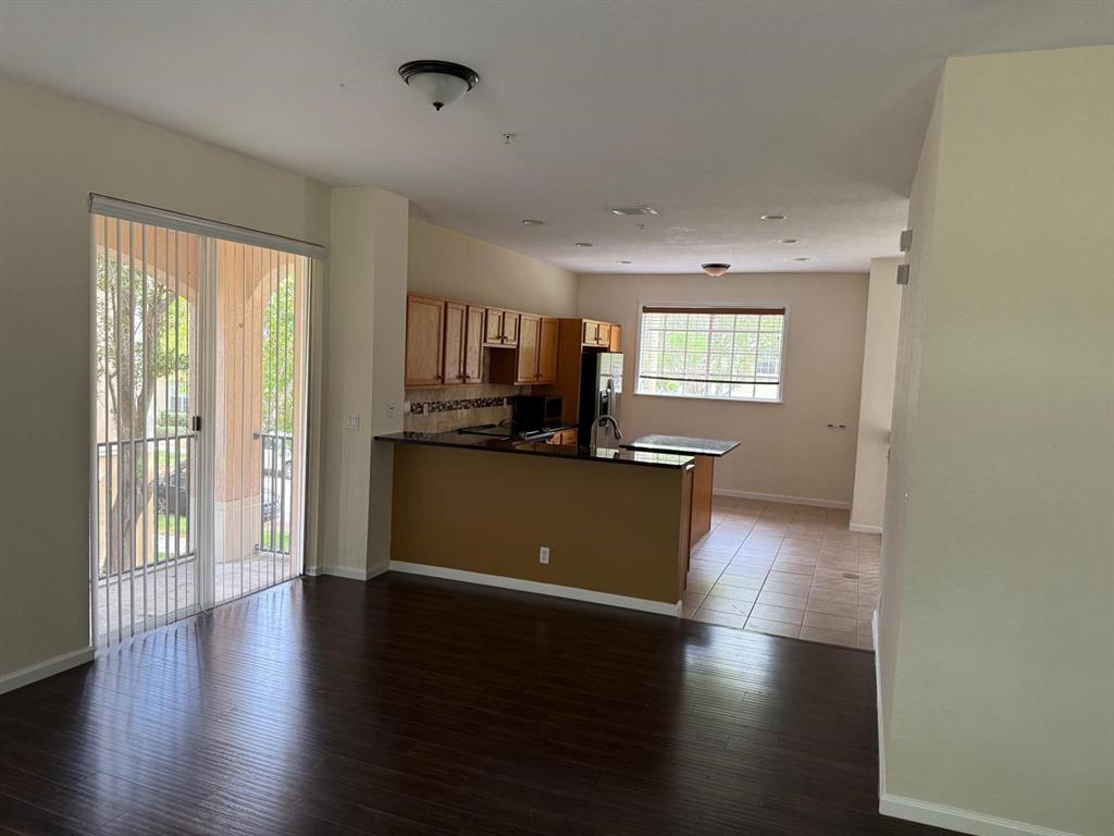 4573 Danson Way Delray Beach, FL 33445 - Photo 19 of 31 a view of a kitchen with wooden floor and a window