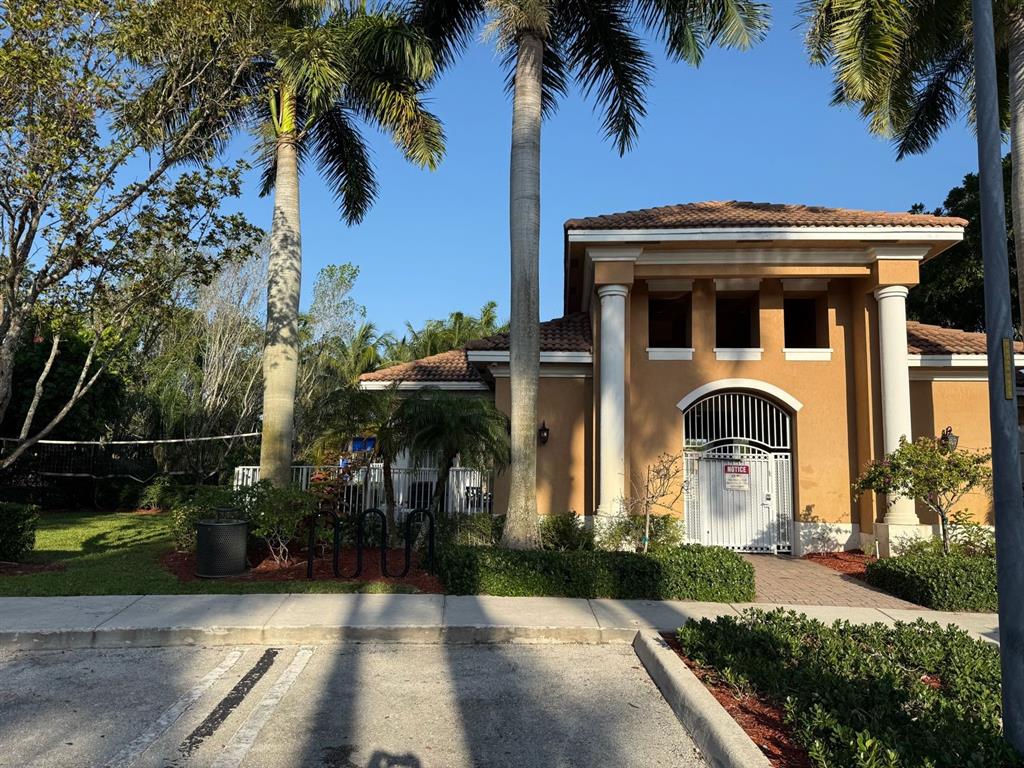 4573 Danson Way Delray Beach, FL 33445 - Photo 23 of 31 a front view of a house with a yard