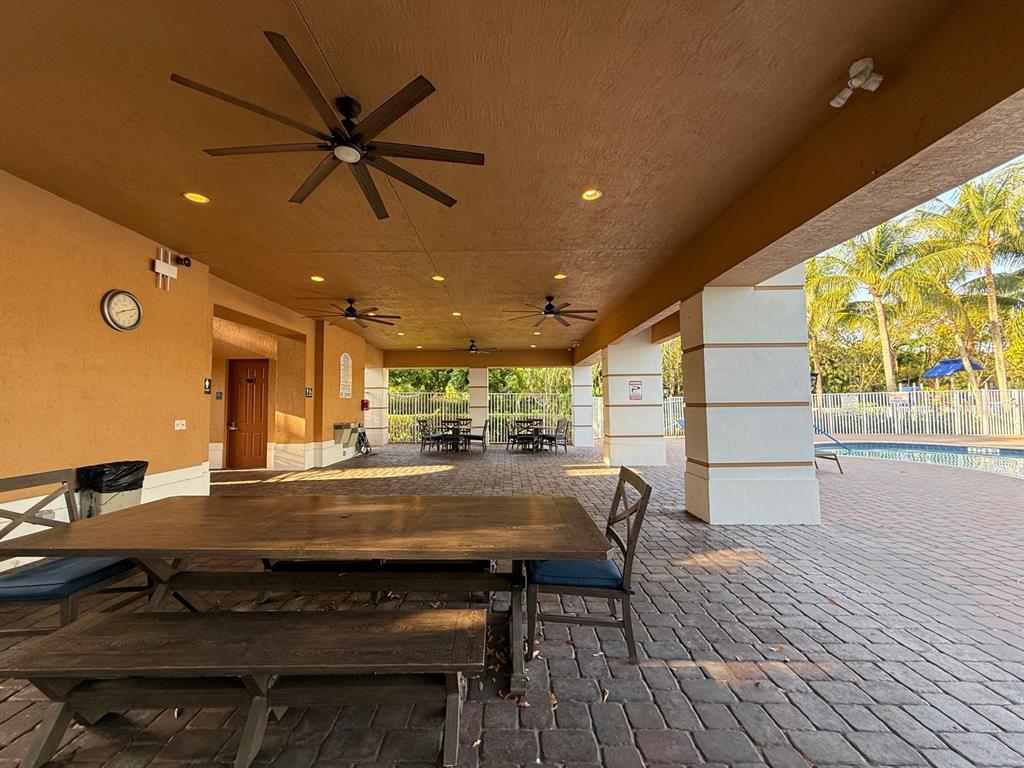 4573 Danson Way Delray Beach, FL 33445 - Photo 28 of 31 a kitchen with a table and chairs