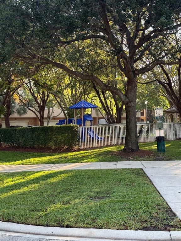 4573 Danson Way Delray Beach, FL 33445 - Photo 31 of 31 a view of yard with swimming pool and green space