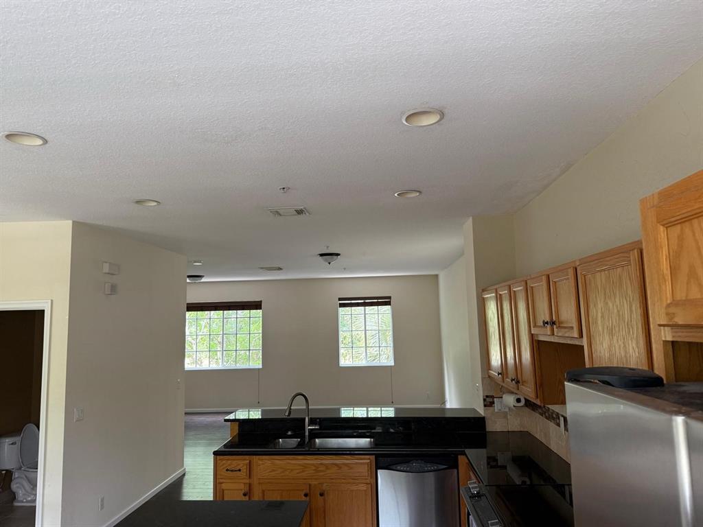 4573 Danson Way Delray Beach, FL 33445 - Photo 6 of 31 a room with a couch and a computer on a desk next to a window