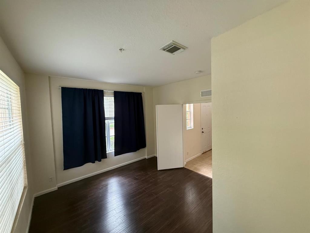 4573 Danson Way Delray Beach, FL 33445 - Photo 7 of 31 an empty room with wooden floor and windows