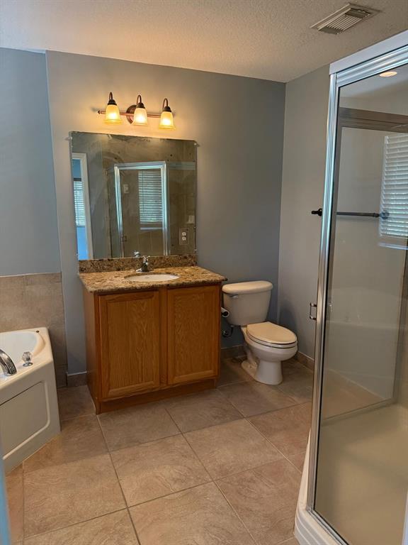 4573 Danson Way Delray Beach, FL 33445 - Photo 8 of 31 a spacious bathroom with a granite countertop sink a toilet and mirror