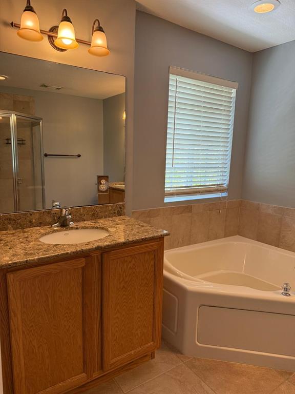 4573 Danson Way Delray Beach, FL 33445 - Photo 9 of 31 a bathroom with a granite countertop sink and a bathtub