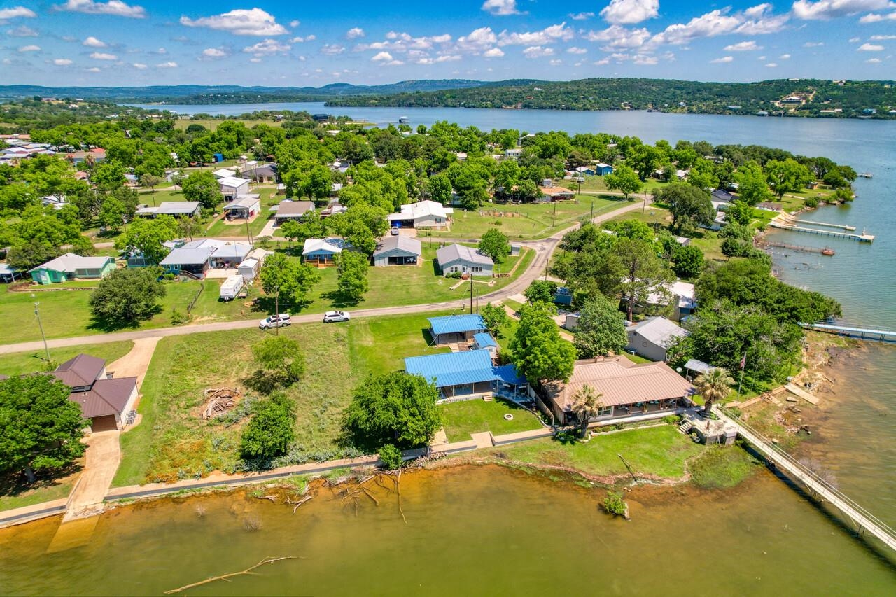 809 Lakeshore Loop Tow, TX 78672 - Photo 32 of 33 an aerial view of a house with a garden and lake view