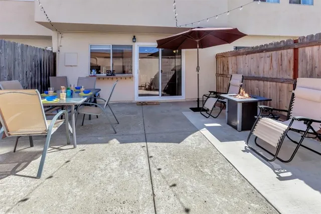 a view of a chairs and table in backyard of the house