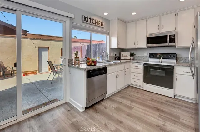 a kitchen with a stove a sink and a microwave