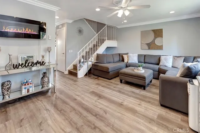 a living room with furniture and a night stand
