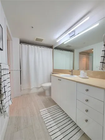 a bathroom with a sink a mirror and a toilet