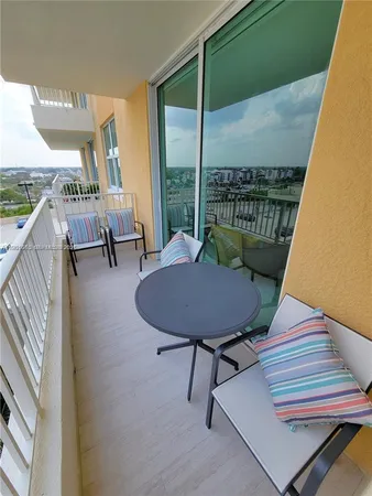 a view of a chairs and table in patio with a lake view