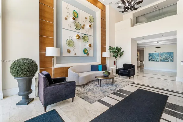 a living room with furniture and a potted plant