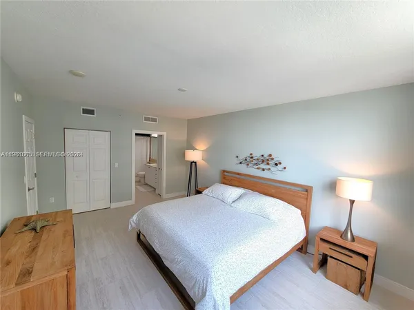 a bedroom with a bed and a lamp