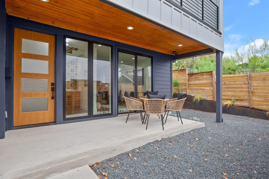 2919 East 13th Street, Unit 2 Austin, TX 78702 - Photo 2 of 20 a view of a patio with a table chairs and wooden fence