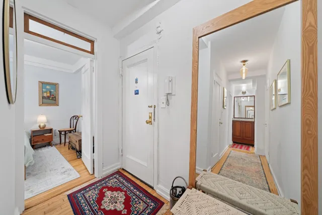 a view of an entryway with wooden floor and a rug