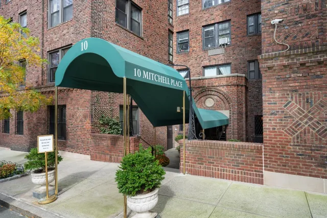 a front view of a building with potted plants