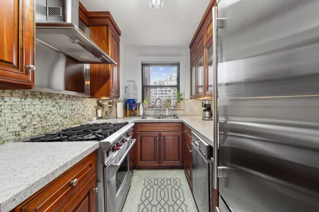 a kitchen with stainless steel appliances granite countertop a stove and a sink