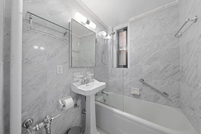 a bathroom with a sink mirror toilet and bathtub