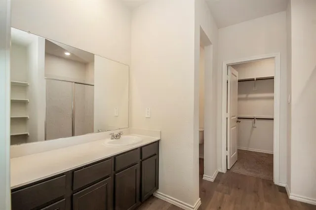 a bathroom with a sink a mirror and a shower