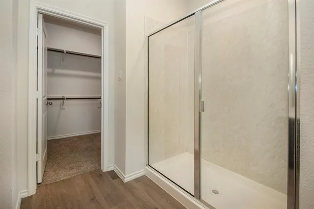a bathroom with a glass shower door
